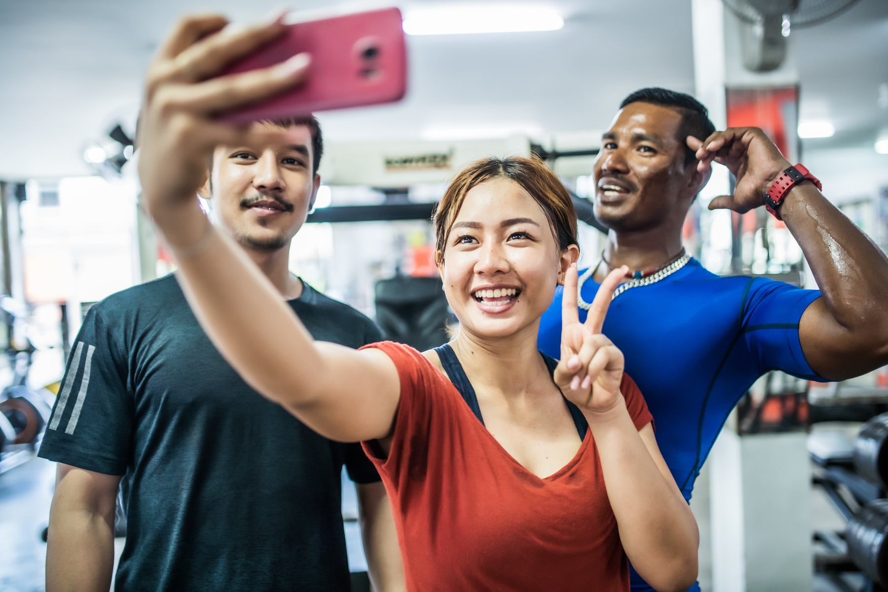 Asian friends taking selfie at the gym